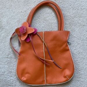 Chic Orange Shoulder Bag with Floral Detail